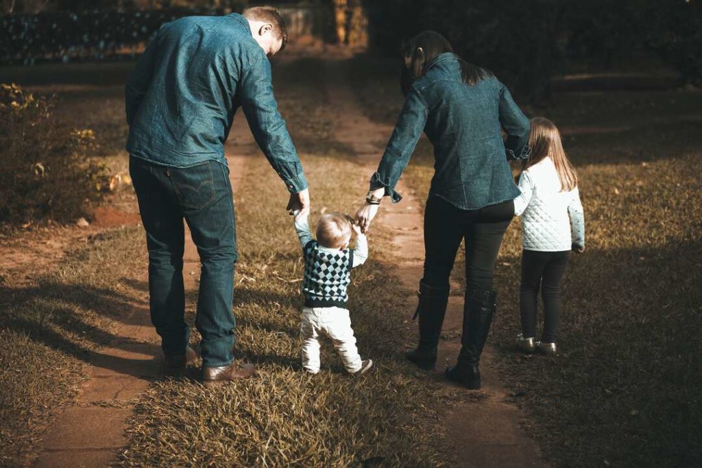 genitori passeggiano con i figli ancora bambini